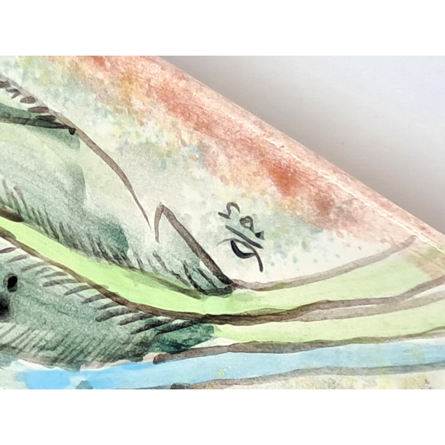 This striking triangular plate features hand-painted lilies in shades of orange and yellow with green leaves. The back is...