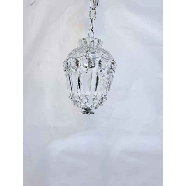 Basket chandelier with glass dish and A-chain crystals. The chandelier is rewired and restored. It has one Edison base...