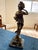 Charming antique French bronze sculpture by A. Moreau, depicting a young girl in flowing dress holding a woven basket,...