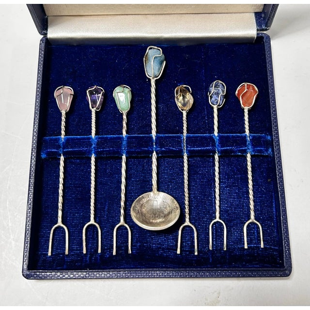 A beautifully handcrafted vintage cocktail pick set featuring six twisted silver-plated hors d'oeuvre picks, each topped...