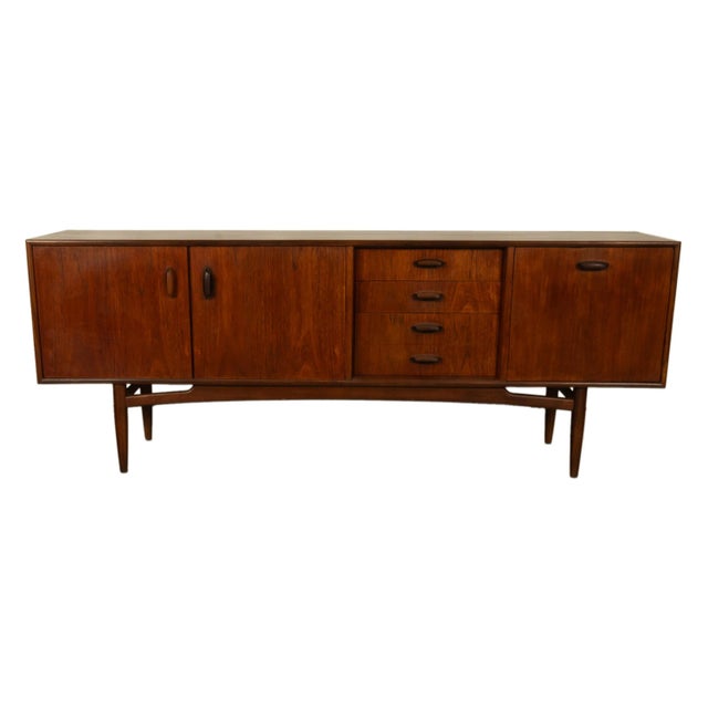 A good Mid Century Modern teak long credenza designed by V. B. Wilkins for G Plan from the Brasilia range, circa 1965. An...