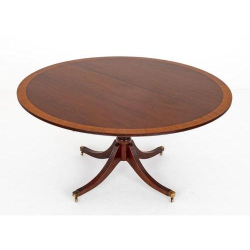 Regency Revival Mahogany Circular Dining Table. Circa 1920 This Table is Raised Upon an Elegant Base with Swept Legs...