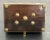 Spectacular rosewood box with brass appliques and binding. Features hidden piano hinge, brass binding to all edges, 4...
