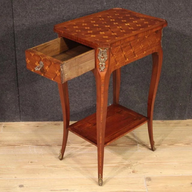 French side table from the mid-20th century. Nicely inlaid furniture with floral and geometric motifs in walnut, rosewood,...