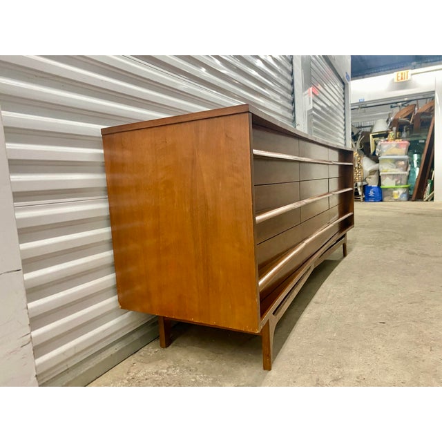 Young Manufacturing style Mid Century Walnut Curved Lowboy Dresser, a collectible item known for its distinct curved front...