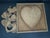 Vintage 20th Century handmade wooden heart puzzle or brain teaser featuring geometric interlocking pieces inside a square...