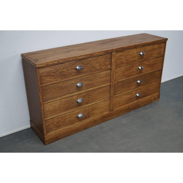 This apothecary cabinet of drawers was designed, circa 1930s in France. The piece is made from oak and features 8 drawers...