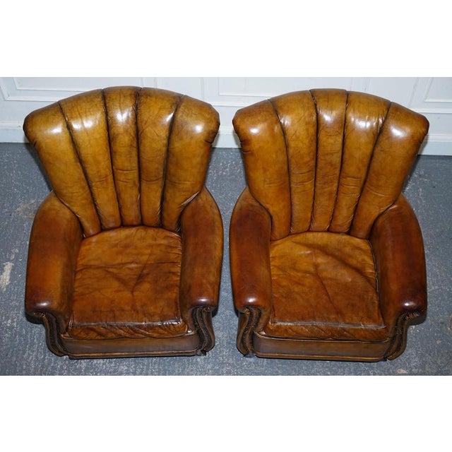 Antiques of London Vintage Pair of Art Deco Style Hand-Dyed Leather Shell Armchairs A striking vintage pair of Art Deco...