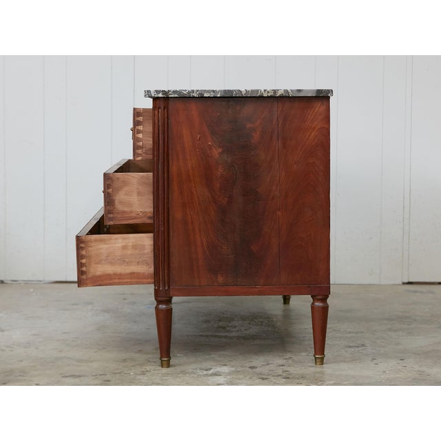 A French walnut commode from the 19th century, with butterfly veneer and grey marble top. Created in France during the...