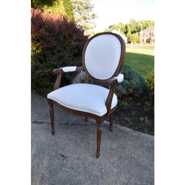 Vintage (1980's) Oval Back Arm Chair has a Francesca Louis XVI Style. Made by Ethan Allen. The Frame is Wood. Carved. The...