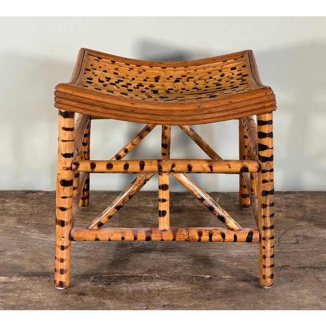 Vintage tiger bamboo stool with a gently curved slatted seat and bold scorched bamboo patterning, constructed in the...