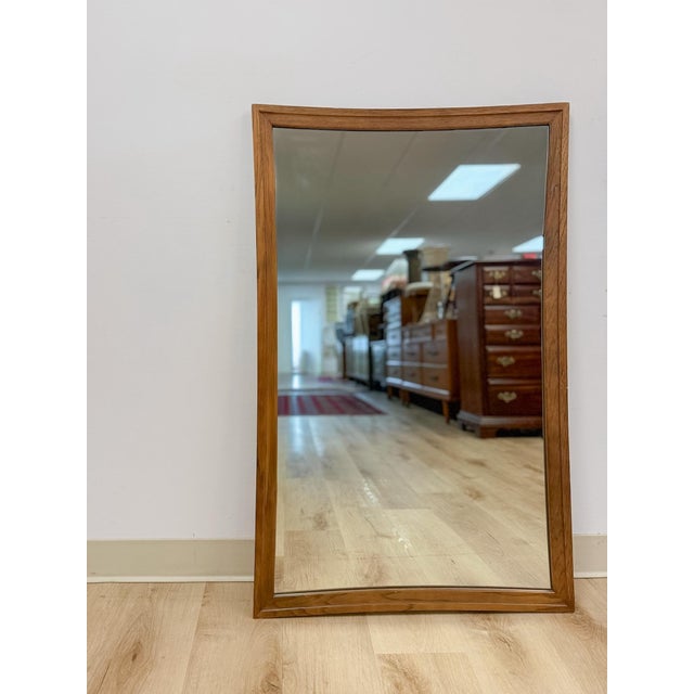 This striking vintage Broyhill Premier Sculptra mid-century modern walnut framed mirror is a highly collectible and sought...