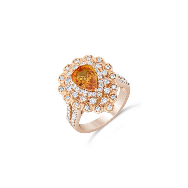 3.02 Carat Natural Pear Cut Orange Sapphire & Diamond Ring in 14K Rose Gold This beautiful ring has a Natural Pear Cut...