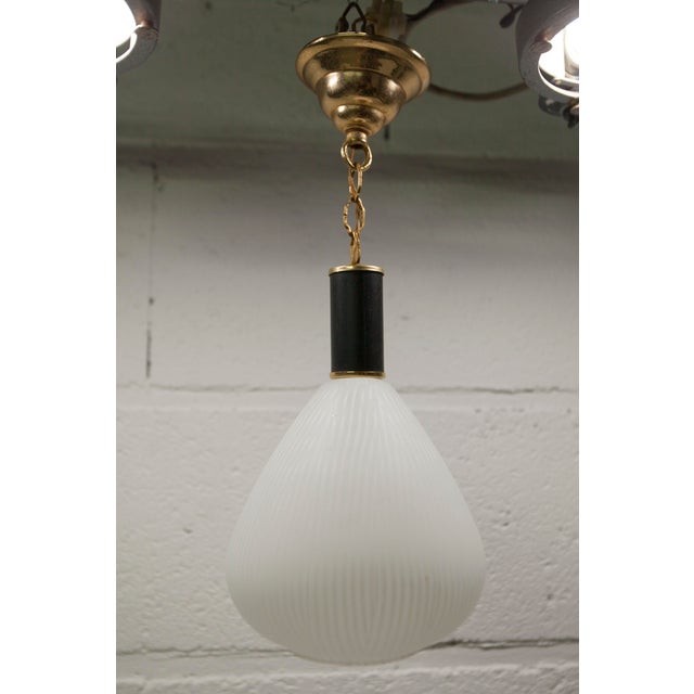 Mid-century brass pendant light with zebra-striped glass shade. In good condition, wiring functional. Up to 250V...