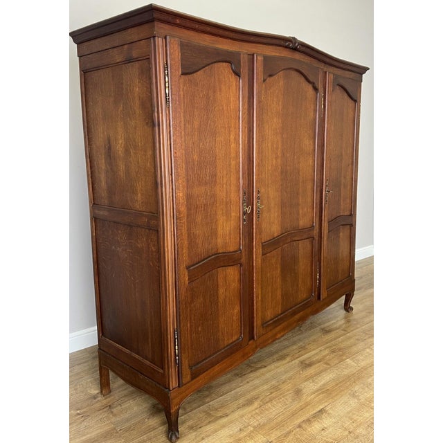 This elegant Vintage French Louis wardrobe combines practical storage with classic French styling. Crafted from oak, it...