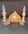 A decorative pair of 19th-century English style giltwood wall sconces, richly carved with scrolling acanthus leaves and...