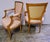 A high quality pair of Louis XVI style fruitwood open armchairs featuring scrolled arms, acanthus leaf carvings, and...