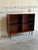 This elegant open shelving unit features a clean double-column layout with a mid-height frame. The minimalist cabinet...