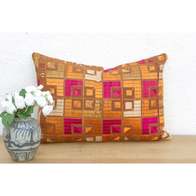 This lumbar pillow is a profound example of Museum-Grade Phulkari, repurposed from a rare 19th-century Heirloom Bagh....