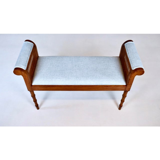 Mid 20th century faux bamboo double caned scroll arm window bench newly upholstered in powder blue textured cotton. Bears...
