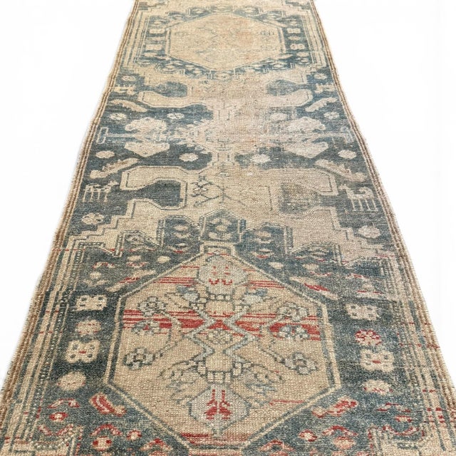 This antique runner embodies a beautifully restrained aesthetic, with a design that leans into simplicity and stylization....