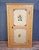 A charming, traditional-style cabinet, crafted from wood and entirely hand-painted, exemplifies the decorative taste of...