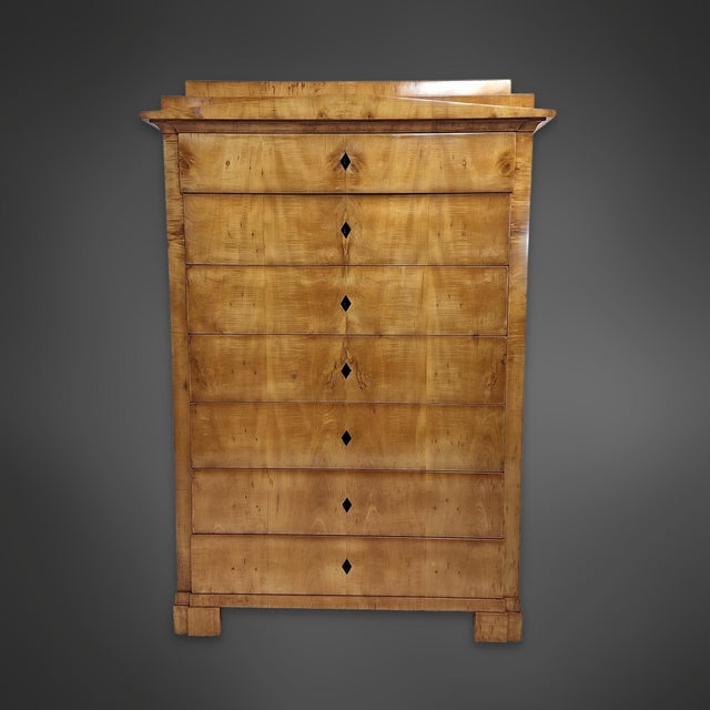 A tall, pillared chest of drawers from the Biedermeier period, featuring seven drawers. The body is made of solid softwood...