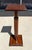 This Bombay Co. wooden plant stand featuring a rich mahogany finish, fluted column detailing, and a classic square...