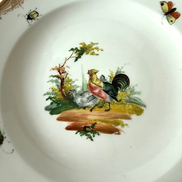 A bird and insects decorate this 8 inch scalloped edge cabinet plate (it is almost a shallow bowl) with gold edging from...