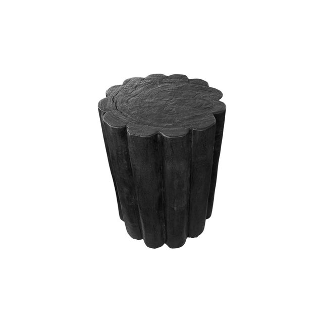 Handcrafted from solid suar wood, this sculptural side table is defined by its striking fluted silhouette and bold...