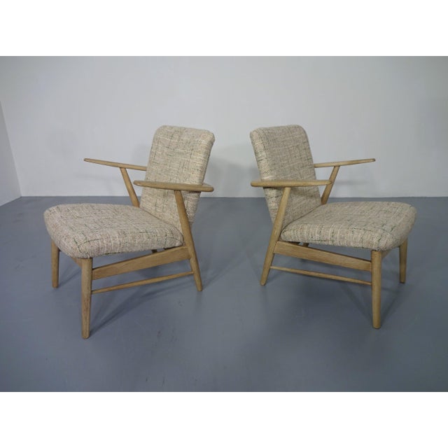 Pair of oak armchairs with armrests. Completely refurbished. Reupholstered in a high-quality Danish wool fabric. The...