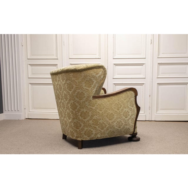 Elegant and characterful 1920s Art Nouveau wingback armchair, beautifully combining sculptural oak detailing with richly...