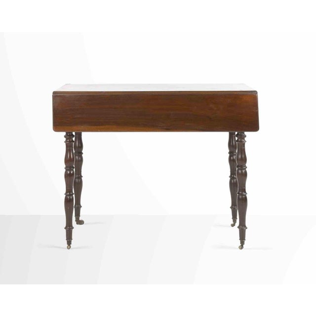 Small solid mahogany side table with side pull and 4 legs with turned columns. Good condition.