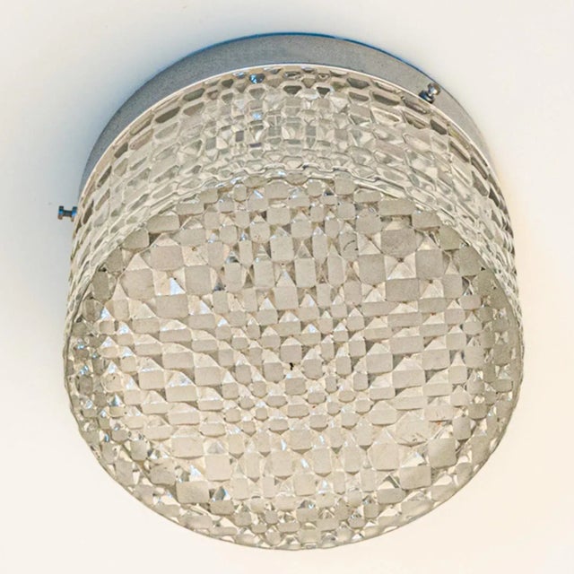 Beautiful clear crystal wall lights/flush mounts, manufactured in germany in 1960. The glass is mounted on a silver...