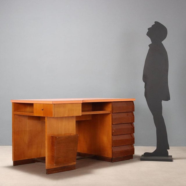 Vintage Italian-made desk with Formica top, drawers, and storage compartments. This piece is attributed to the mentioned...