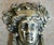 A cast brass door knocker shaped like the head of Dionysus crowned with an ivy wreath. Made from brass, remains in...