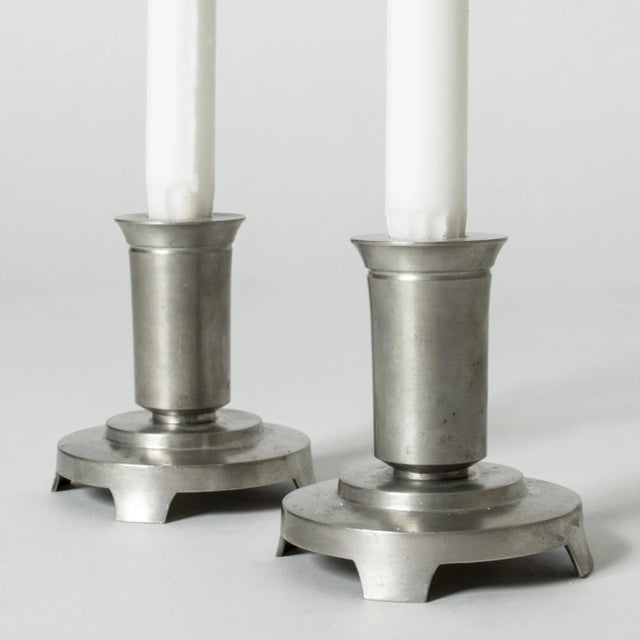 Pair of elegant pewter candlesticks from Just Andersen. Crisp lines, made for regular candles. This piece has an...