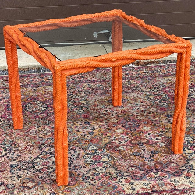 Vintage faux bois center table featuring a carved wooden frame resembling twisted twigs. Inset glass top 23.5”x23.5”