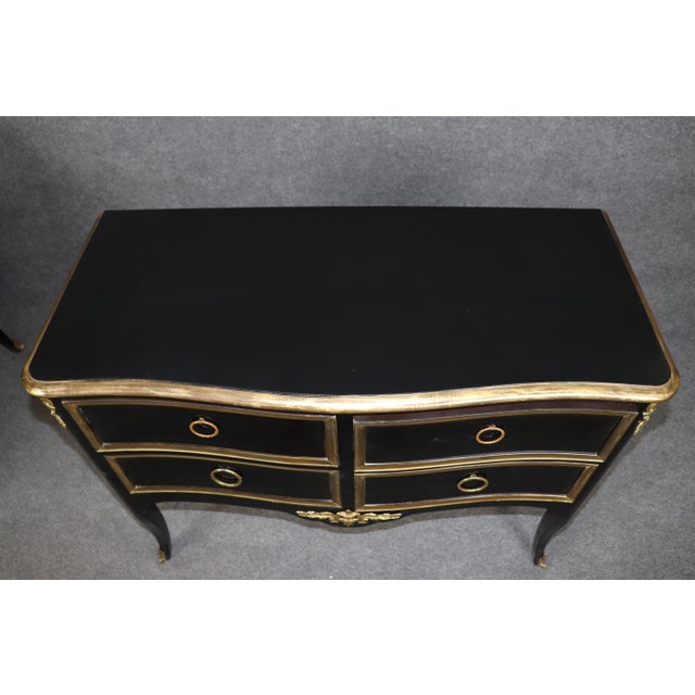 A sophisticated and highly decorative pair of vintage Louis XV style commodes by the renowned furniture maker Jacques...