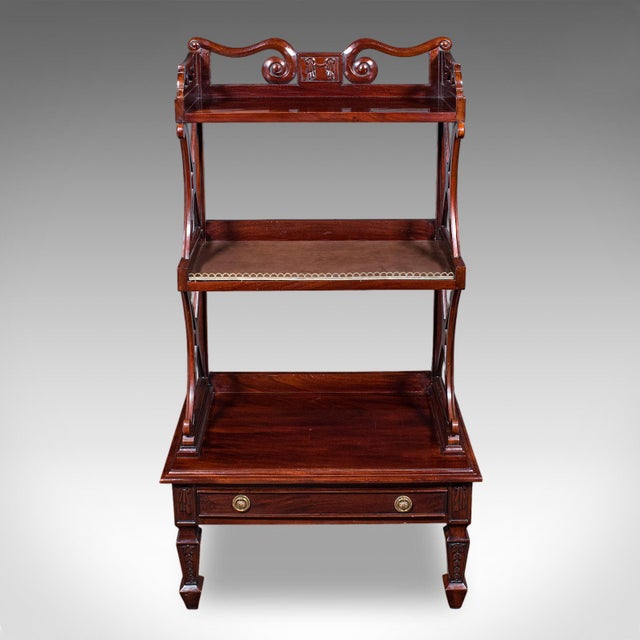 This is a vintage waterfall bookcase. An English, mahogany whatnot or open book shelf in Regency revival taste, dating to...