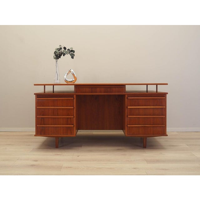 The desk was made in the 1970s in Denmark. The frame and tabletop are covered with teak veneer. The legs are made of solid...