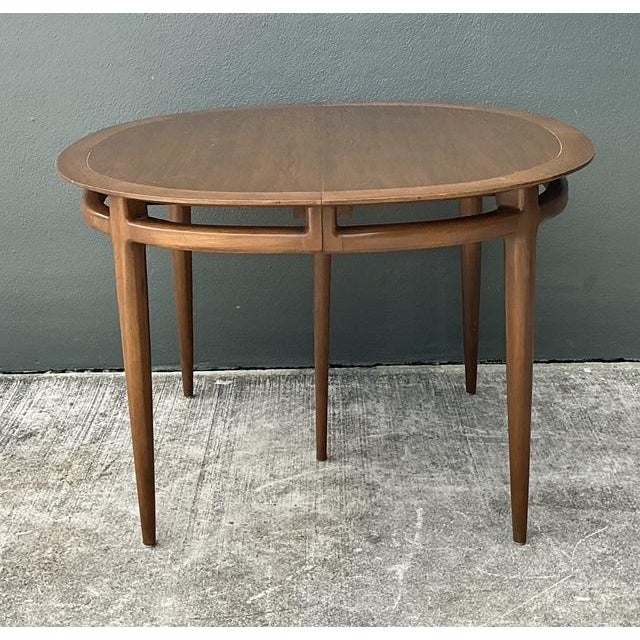 This exceptional 1960s dining table is a prime example of high-end Mid-Century Modern craftsmanship, featuring a rare...