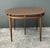 This exceptional 1960s dining table is a prime example of high-end Mid-Century Modern craftsmanship, featuring a rare...