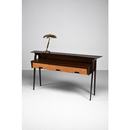 Vintage Italian dressing table with elegant shapes. This stunning 50’s design is made of wood and wood veneer with...