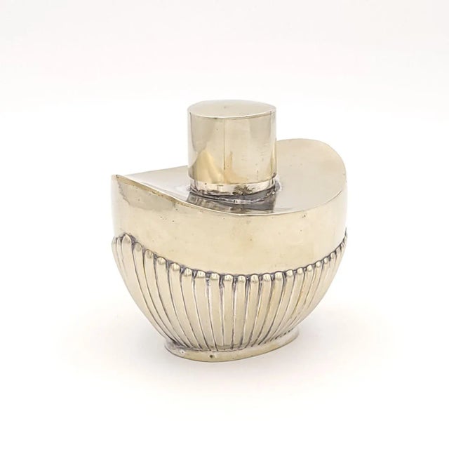An elegant English silver on brass smaller oval tea caddy, 19th century.