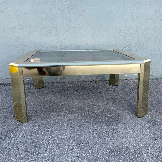 Striking vintage Art Deco style coffee table featuring a sleek geometric silhouette with clipped corners and a smoked...