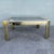 Striking vintage Art Deco style coffee table featuring a sleek geometric silhouette with clipped corners and a smoked...