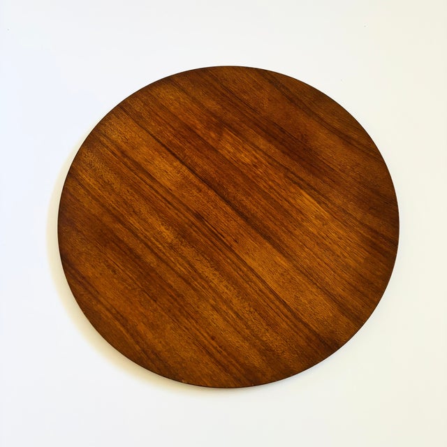 A mid century circular teak tray. Lovely simple design with an edge that curves slightly upward along the perimeter.