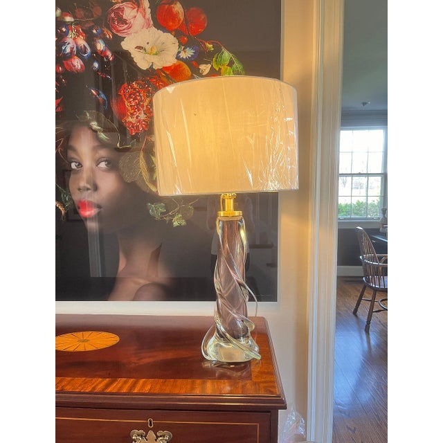 This contemporary lamp is in the mid century style of the twisted glass lamps produced by Flygsfors, Sweden. The warm...