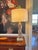 This contemporary lamp is in the mid century style of the twisted glass lamps produced by Flygsfors, Sweden. The warm...